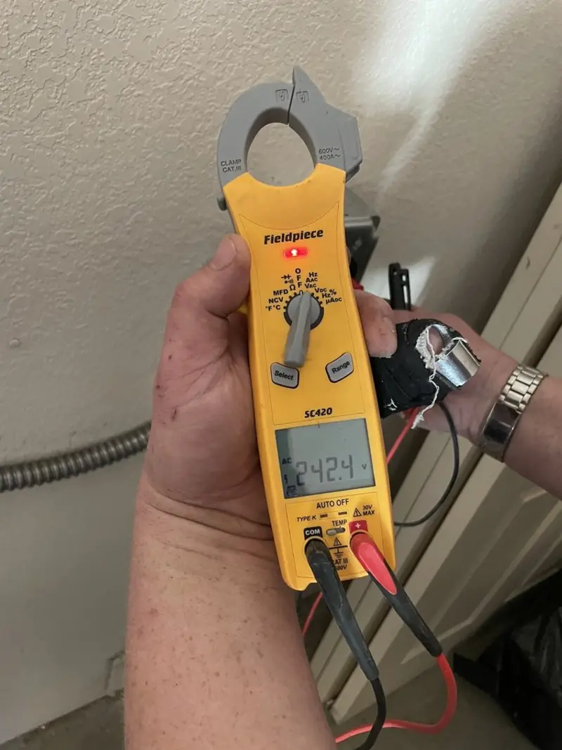 Voltage testing with clamp meter during Outlet Installation in Albertville